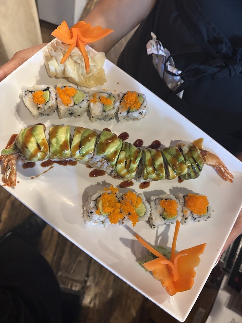 Sushi plates beside white booth seating.